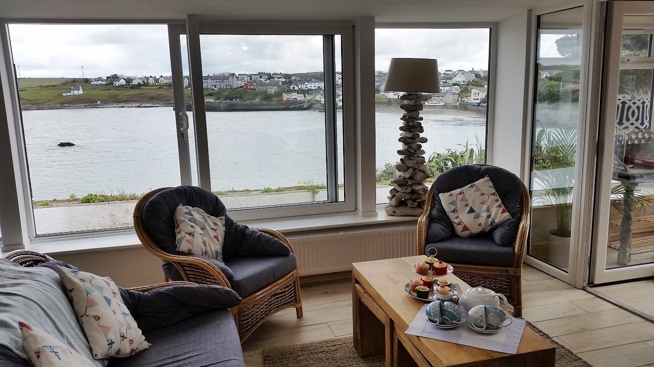 Main lounge with BT TV and views over the bay.